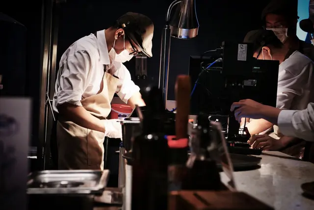 Professional chefs preparing food in a commercial restaurant kitchen