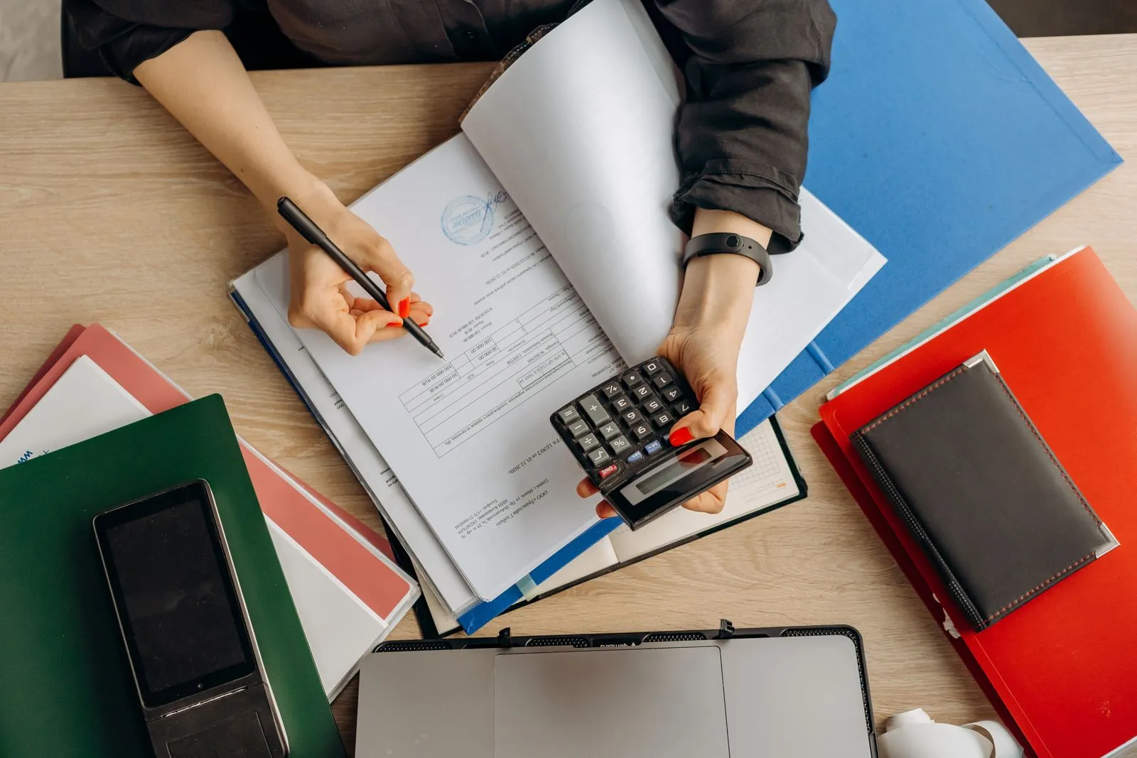 Financial documents being reviewed at an accountant's desk